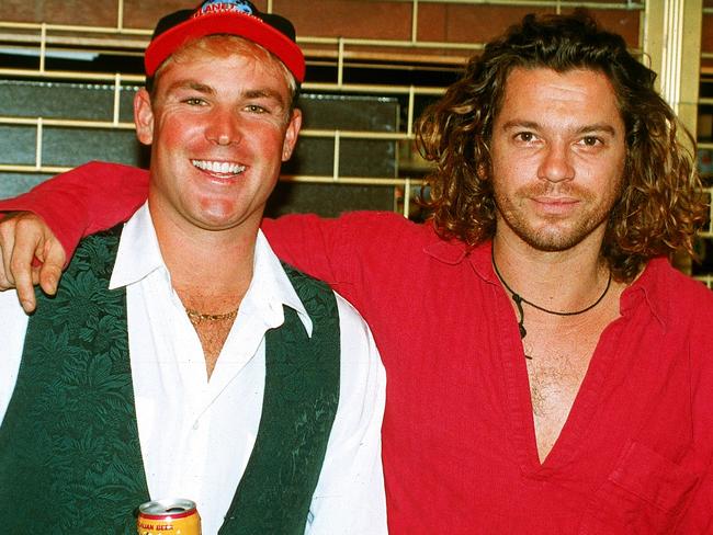 (FILE PHOTO) LONDON - 1993:  (L-R) Australian cricketer Shane Warne poses for a photo with Michael Hutchence, lead singer of INXS July, 1993 in London, England. (Photo by Getty Images)