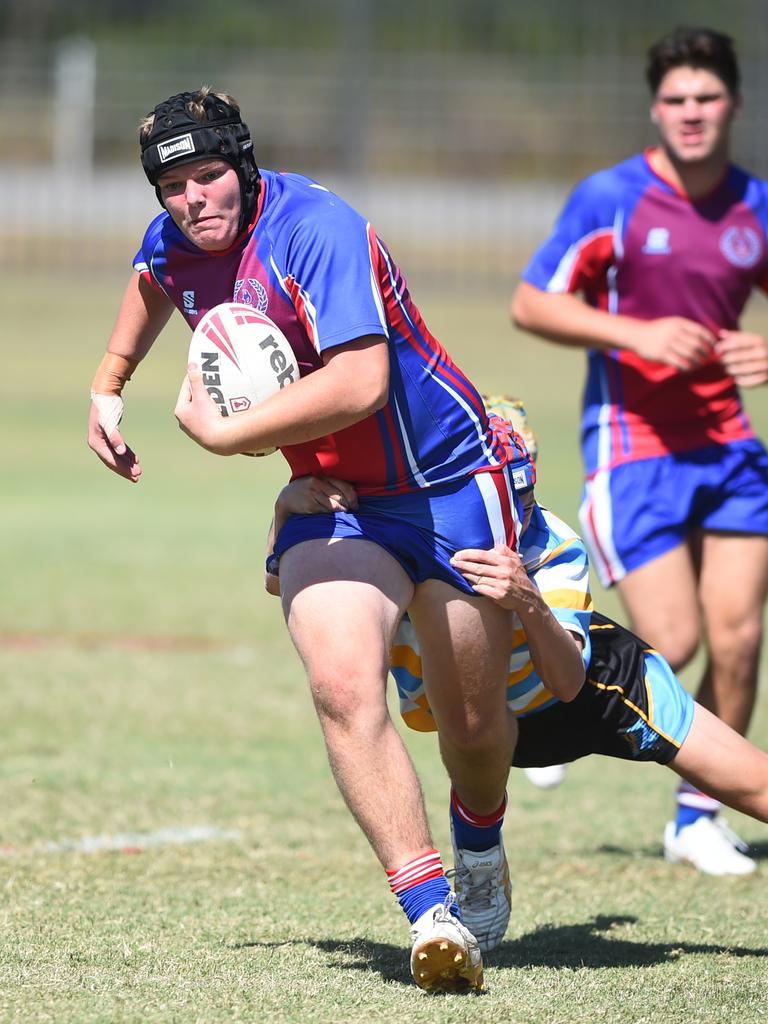 Boys Rugby League State Championship held at Northern Division, Brothers Leagues ground, Townsville. 16-18 years. Peninsula (stripe) v Darling Downs (blue/purple). Thomas Fenwick of Toowoomba Grammar School.