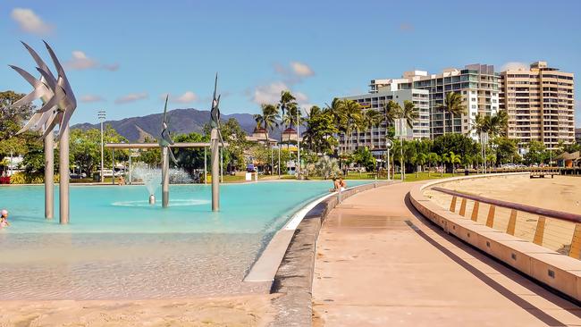 View of Cairns Esplanade Lagoon, a large public pool next to the beach in Cairns, Queensland, Australia.