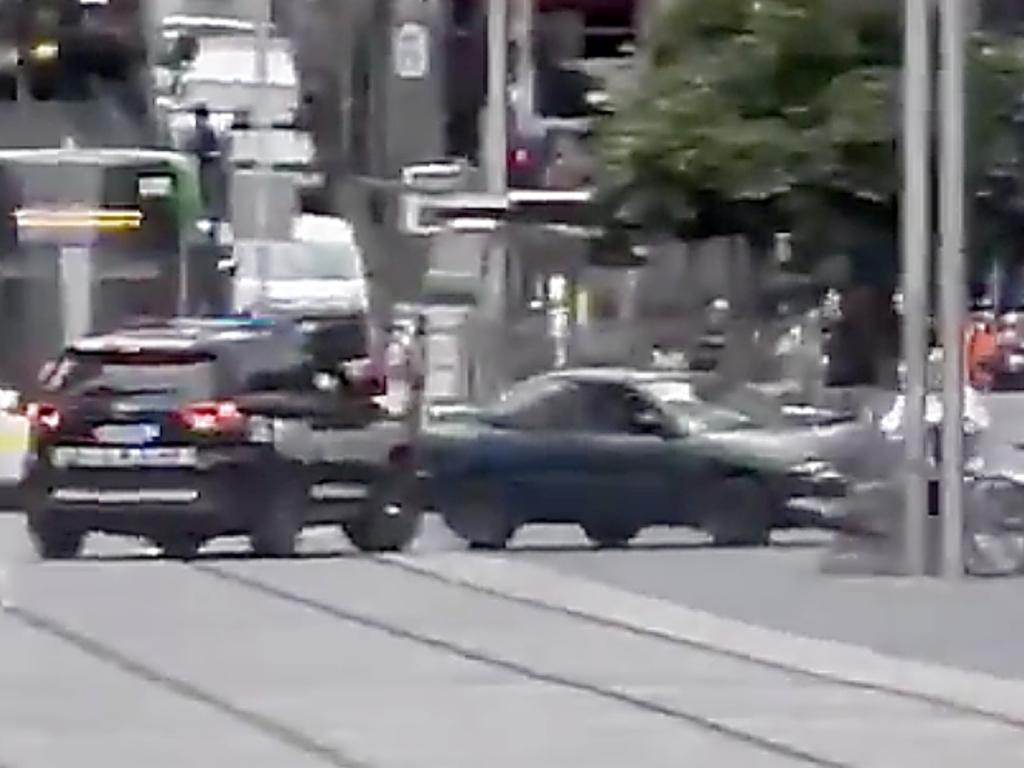 A green car being pursued by police crashes into a bollard in the Bourke Street Mall. Picture: Supplied