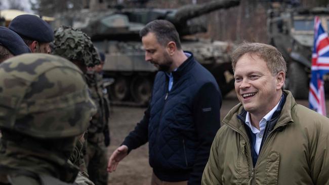 UK Secretary of Defence Grant Shapps (right) and Polish Defence Minister Wladyslaw Kosiniak-Kamysz (second right) greet and chat with British and Polish troops. Picture: Wojtek Radwanski / AFP