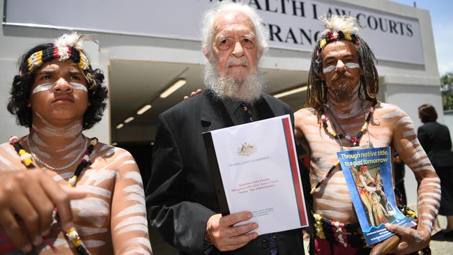 Quandamooka elder Bob Anderson, flanked by traditional dancers, holds the native title to Moreton Island. Picture: AAP