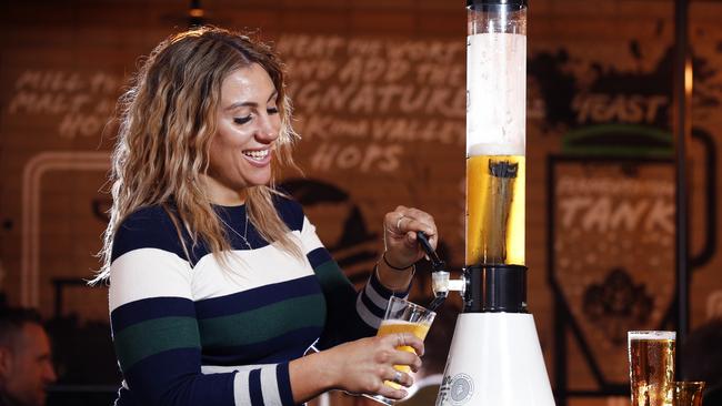 Amanda Pozzobon pours her own glass of beer from the beer tower. Picture: David Caird