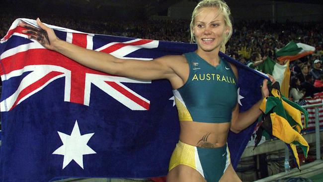Tatiana Grigorieva holding Australian flag after placing second in women’s pole vault final event at Sydney Olympic Games 2000.