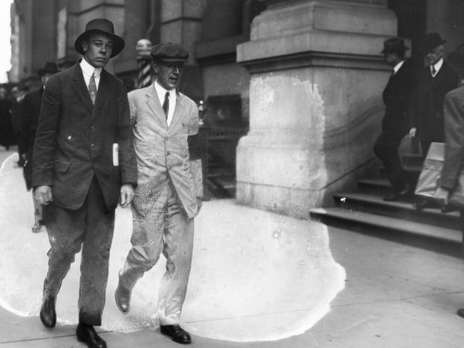 Author Upton Sinclair, in white suit with black arm band, picketing Rockefeller Building in 1914. US Library of Congress pic, public domain