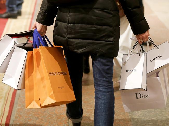 A customer carries shopping bags from Louis Vuitton, a unit of LVMH Moet Hennessy Vuitton SE, Chanel SA and Christian Dior SE brands after shopping at luxury boutiques at the G.U.M. department store in Moscow, Russia, on Wednesday, Dec. 28, 2016. President-elect Donald Trump said Wednesday that the U.S. should move on rather than retaliate against Russia for interfering in the 2016 election, with the Obama administration expected to soon take action against Moscow. Photographer: Andrey Rudakov/Bloomberg via Getty Images