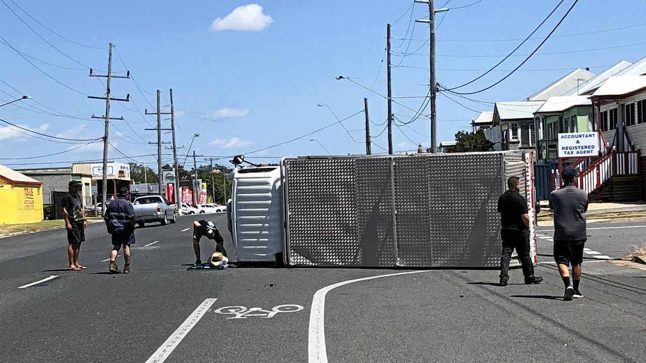 CRASH: A man in his 50's was assisted by people after his vehicle rolled at the corner of Kent and Derby St. Picture: Maddelin Mccosker