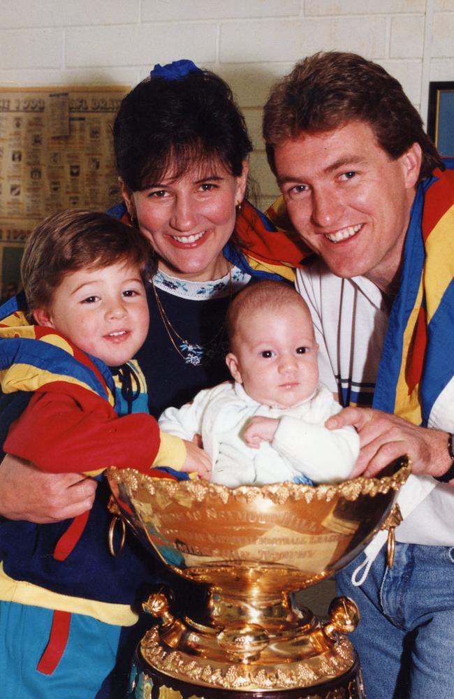 GOLD: Peter and Katia Schwarz with Nicolas and Thomas (in the trophy) in 1993, the day after the then newly merged Eagles won the SANFL flag.