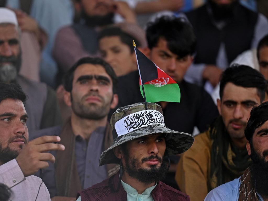 A spectator wearing a hat with an Afghanistan flag and Taliban ribbon watches a match in Kabul. Picture: Aamir Qureshi/AFP