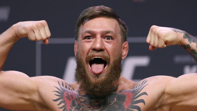 Conor McGregor poses during a ceremonial weigh-in