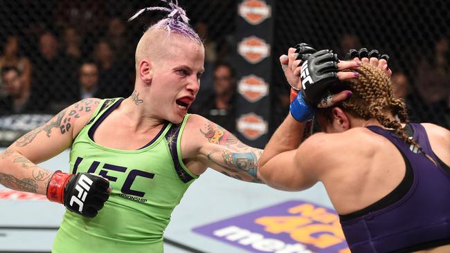 Bec Rawlings punches Heather Jo Clark in their strawweight fight during The Ultimate Fighter Finale event.