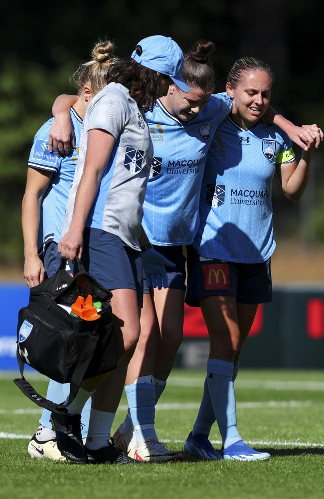 Kirsty Fenton is helped from the field after injuring her knee. Picture: Hagen Hopkins/Getty Images