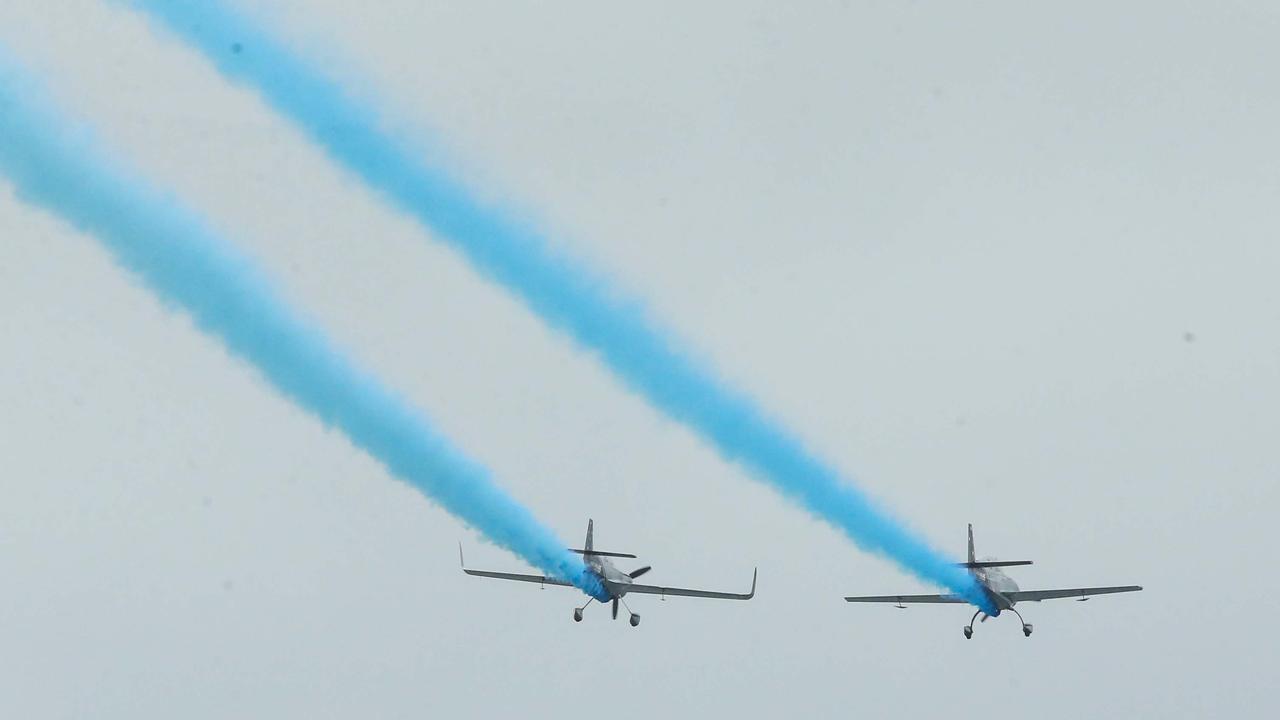 Two planes dropped a streak of blue, confirming the couple would be welcoming a boy. Picture: Matrix Media Group