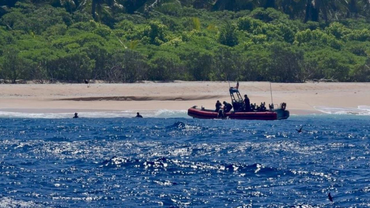 Three castaways were saved by the ingenious “HELP” sign they laid out on sand using palm leaves. Picture: Facebook/US Coast Guard Forces Micronesia