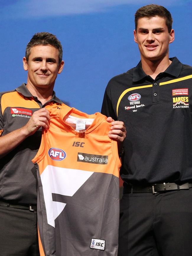 Boy with GWS coach Leon Cameron at the 2013 national draft.