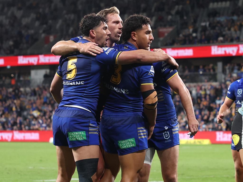 SYDNEY, AUSTRALIA - MAY 30: Will Penisini of the Eels celebrates with team mates after scoring a try during the round 13 NRL match between Parramatta Eels and Cronulla Sharks at CommBank Stadium on May 30, 2024, in Sydney, Australia. (Photo by Cameron Spencer/Getty Images)