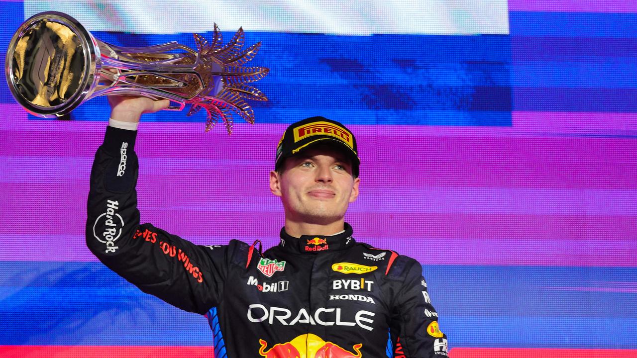 Red Bull Racing's Dutch driver Max Verstappen lifts his trophy in Jeddah. Photo by Giuseppe CACACE / AFP.