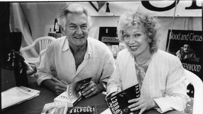 Former Prime Minister Bob Hawke sitting alongside his wife Blanche d'Alpuget as she signs copies of her book 