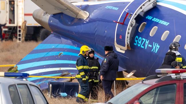 TOPSHOT - Emergency specialists work at the crash site of an Azerbaijan Airlines passenger jet near the western Kazakh city of Aktau on December 25, 2024. The Embraer 190 aircraft was supposed to fly northwest from the Azerbaijani capital Baku to the city of Grozny in Chechnya in southern Russia, but instead diverted far off course across the Caspian Sea. It crashed on December 25, 2024 near the city of Aktau in Kazakhstan. (Photo by Issa Tazhenbayev / AFP)