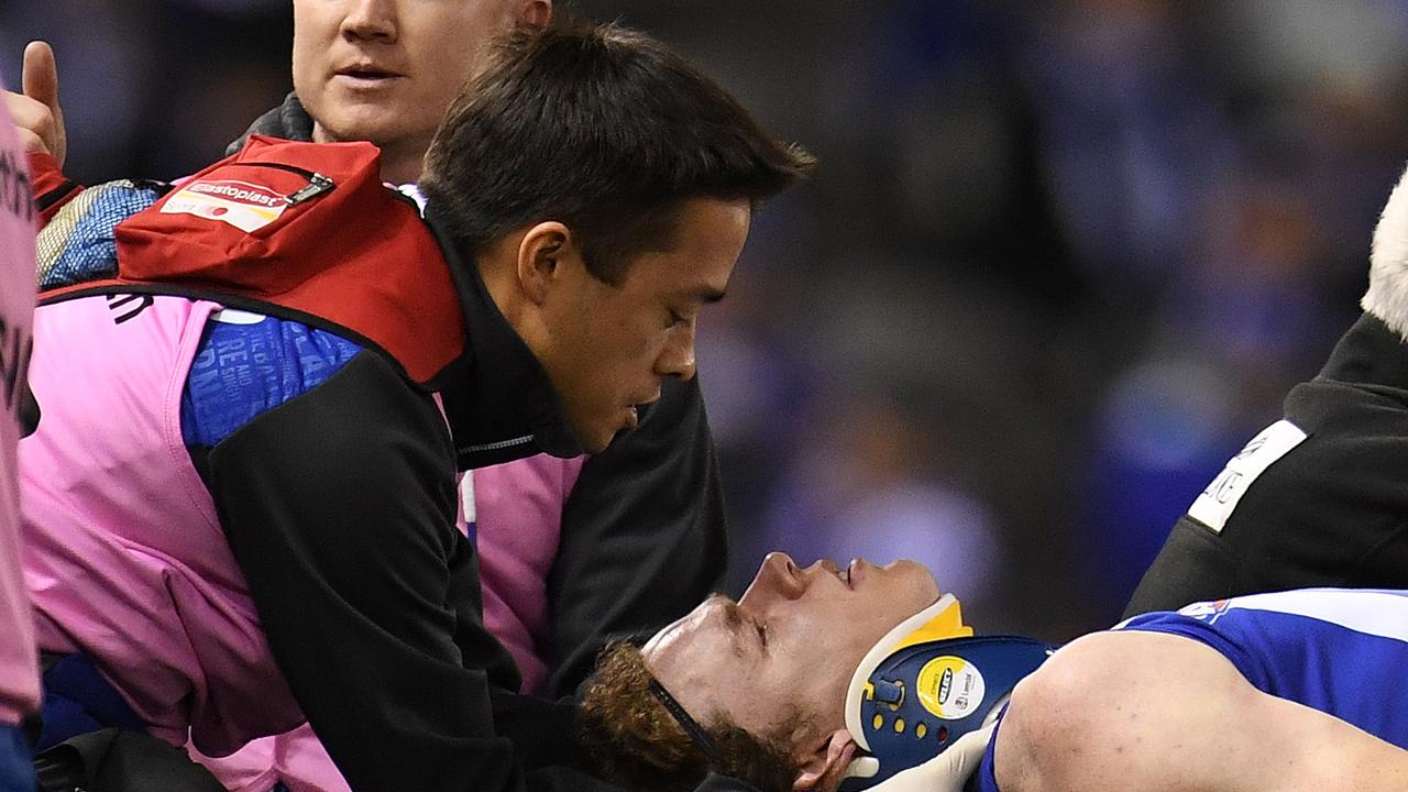 Ben Brown of the Kangaroos (right) is treated for concussion in 2017. Picture: AAP Image/Julian Smith