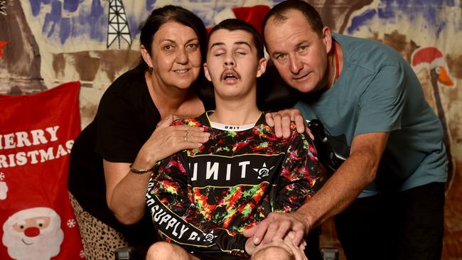 Trent Atto, with his mum Debbie Watson and dad Ray Atto at Rolad McDonald House, is recovering from a severe brain injury. Picture: Evan Morgan