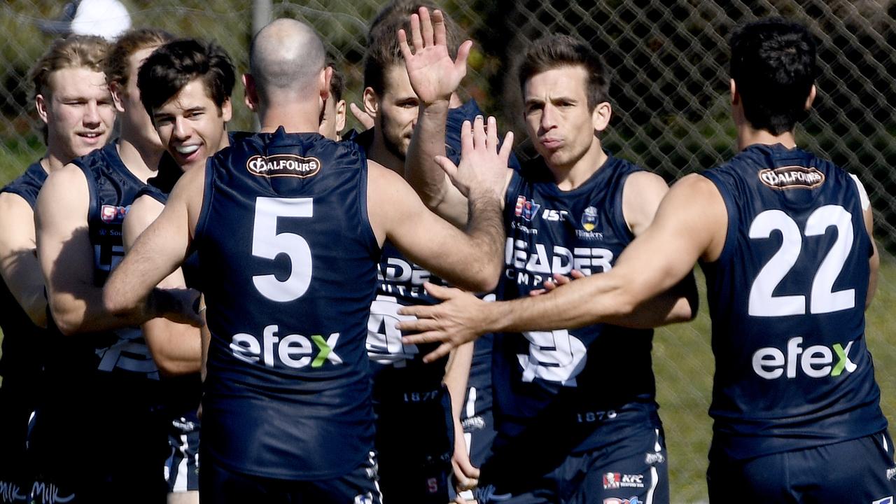 ADELAIDE, AUSTRALIA - AUGUST 29, 2020: Action from the South Adelaide/Central District SANFL game in Noarlunga - South Adelaide team mates congratulate Joel Cross on a goal. Picture: Naomi Jellicoe