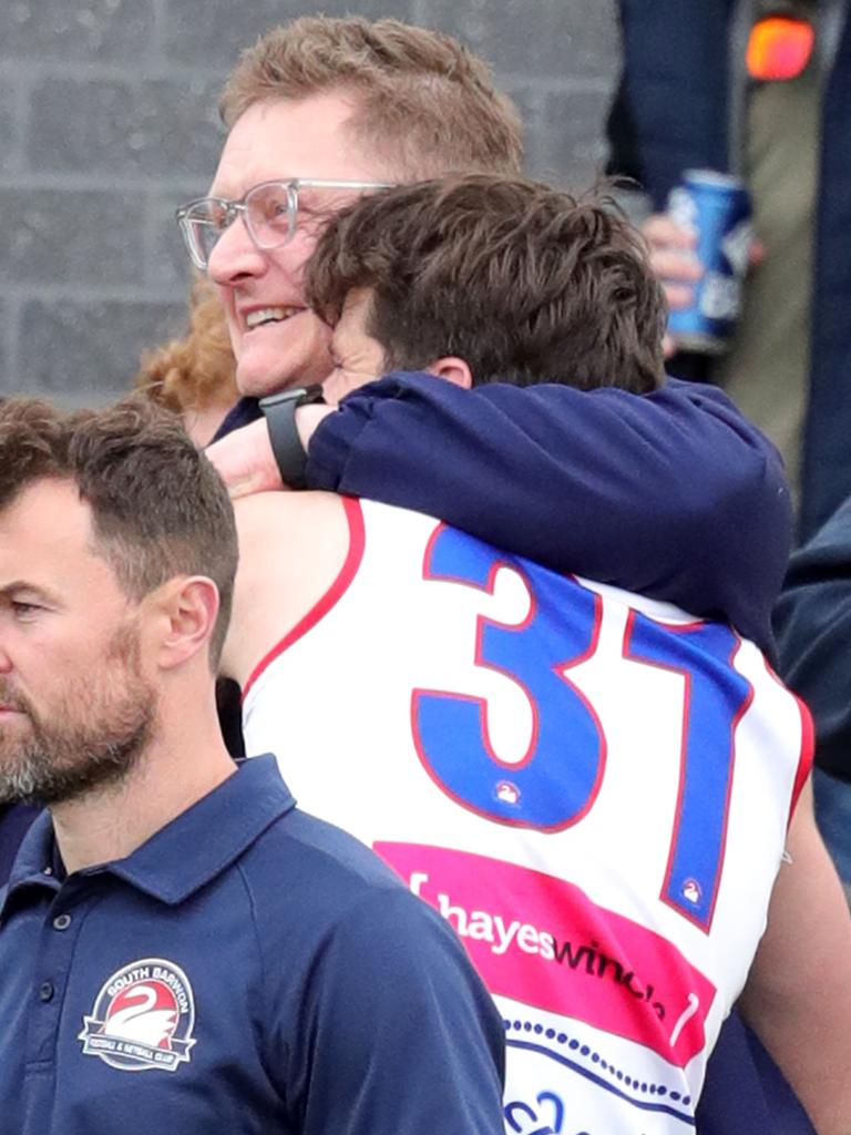 South Barwon coach Mark Neeld and Matt Caldow embrace after the Swans’ 30-point win over St Joseph’s. Picture: Mark Wilson