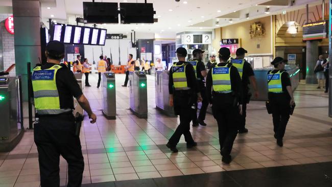 PSOs patrol Flinders Street Station the morning after New Year’s Eve celebrations. Picture: David Crosling