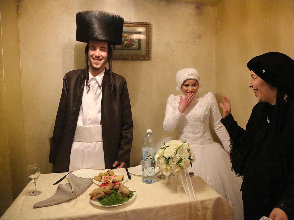 Second Place — “First Time” by Agnieszka Traczewska / National Geographic Traveler Photo Contest. Mea Shearim, ultra Orthodox district of Jerusalem. Newly married, Aaron and Rivkeh after the wedding ceremony are to stay together for the very first time, alone. Their marriage was arranged by families. 18 years old candidates confirmed the choice in result of the one meeting only. Since then until the wedding day they were prohibited to meet or even talk. Location: Mea Shearim, Jerusalem, Israel. Picture: <a href="http://travel.nationalgeographic.com/travel/traveler-magazine/photo-contest/2014" target="_blank">National Geographic Photo Contest </a>