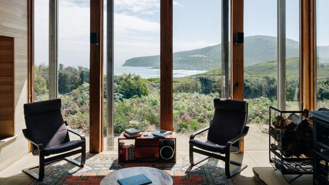 Roaring Beach House's spacious living area which features towering floor-to-ceiling windows which makes the most of the stunning outlook. Picture: Adam Gibson.