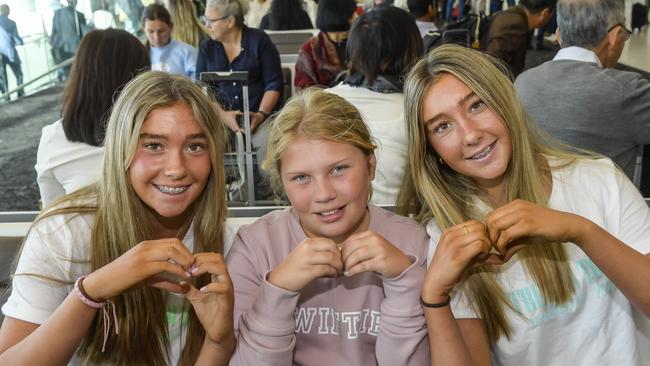 Ruby Elmes, 14, Billie Dawson, 11, and Coco Elmes, 14 waiting for their flight to Melbourne. Picture: Roy VanDerVegt