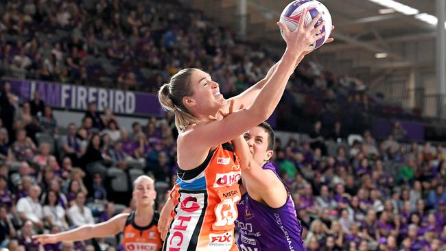 Caitlin Bassett of the Giants leaps for possession over Laura Clemesha of the Firebirds. Picture: Getty Images