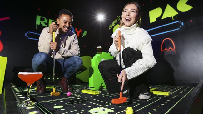 Louis Rolfe and Kate Quane playing putt putt golf at Holey Moley in Potts Point. Picture: Justin Lloyd