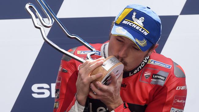 Miller celebrates his latest win with a kiss on the podium. Picture: AFP