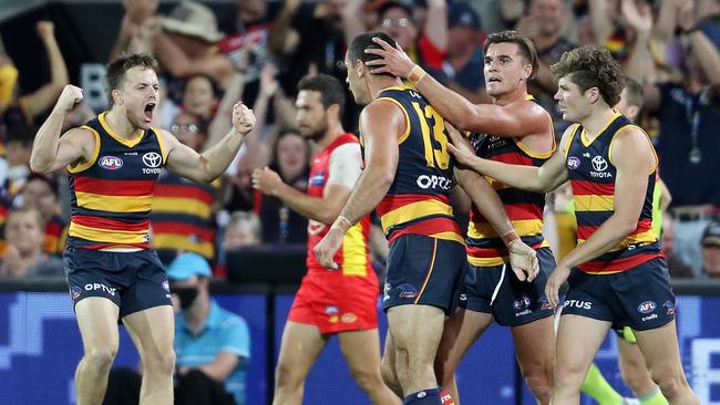 Crows James Rowe, Ben Keays and Harry Schoenberg celebrate one of Taylor Walker’s six goals. Picture: Sarah Reed/AFL Photos