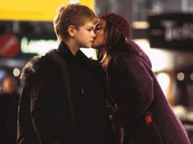 Scene stealer ... Joanna (Olivia Olson) plants a kiss on Sam’s (Thomas Brodie-Sangster) cheek in Love Actually. Picture: Supplied