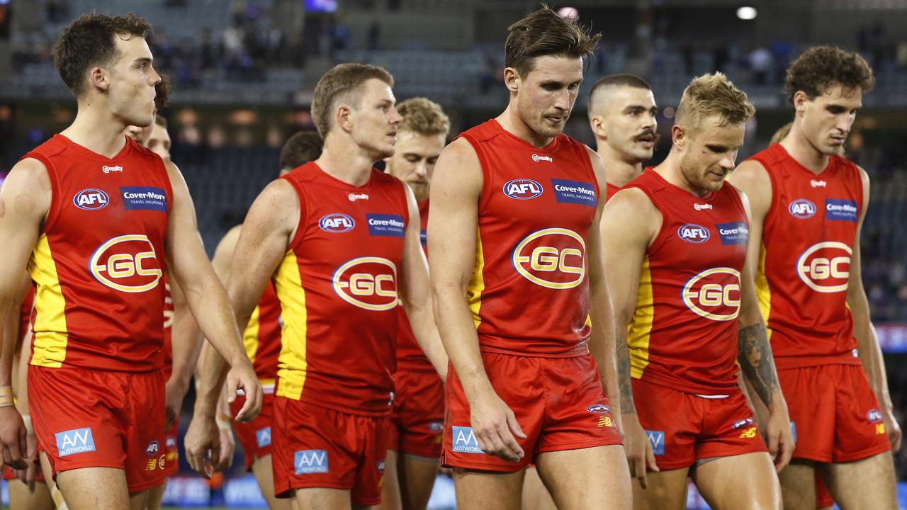 MELBOURNE, AUSTRALIA - APRIL 17: Dejected Gold Coast Suns players walk from the ground after the round five AFL match between the Western Bulldogs and the Gold Coast Suns at Marvel Stadium on April 17, 2021 in Melbourne, Australia. (Photo by Darrian Traynor/AFL Photos/via Getty Images)