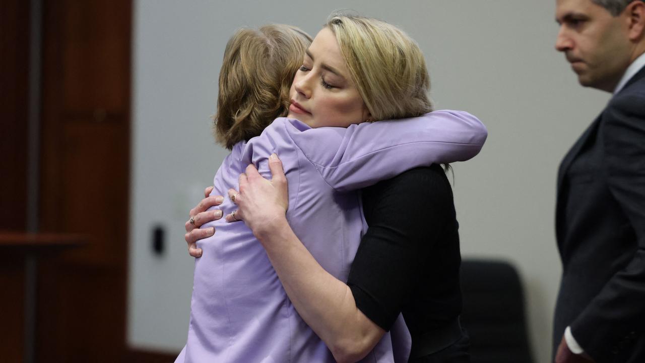 Amber Heard hugs her lawyer Elaine Bredehoft after the jury announced split verdicts. (Photo by EVELYN HOCKSTEIN / POOL / AFP)