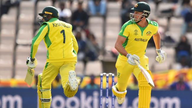 Australia's Usman Khawaja (L) and Australia's Marcus Stoinis (R) take a run during the 2019 Cricket World Cup warm up match between Australia and Sri Lanka at the Rose Bowl in Southampton, southern England, on May 27, 2019. (Photo by Glyn KIRK / AFP)