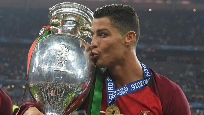 Portugal's forward Cristiano Ronaldo kisses the Euro 2016 trophy.