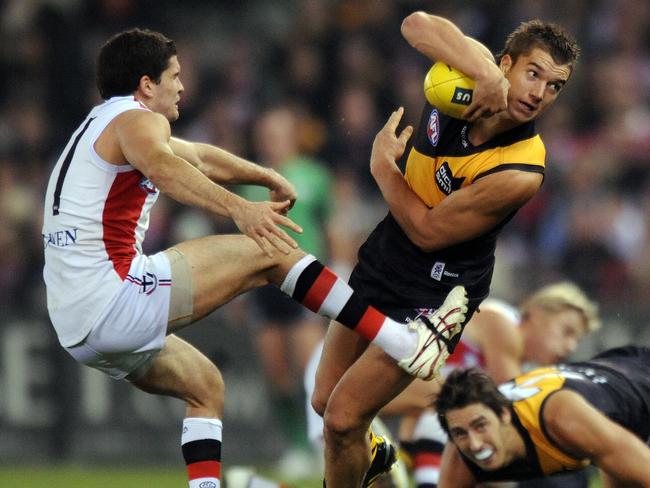 Dustin Martin of Richmond is tackled by Leigh Montagna of St Kilda during their round 11 match of the AFL season, played at Etihad stadium in Melbourne, Friday, June 4, 2010. (AAP Image/ Joe Castro) NO ARCHIVING, EDITORIAL USE ONLY