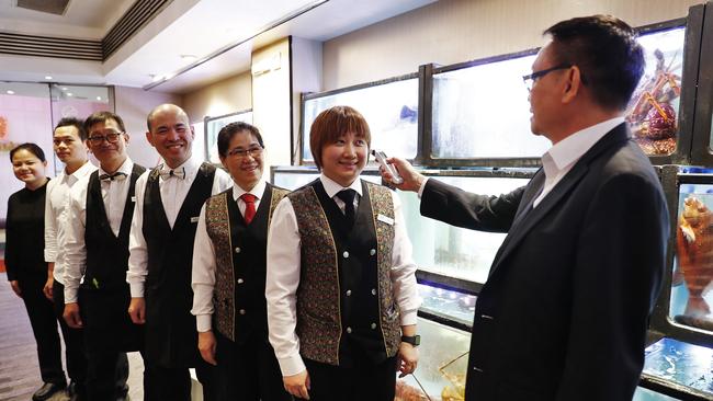 Owner of famous Sydney Chinese restaurant Golden Century, Eric Wong, pictured checking the temperatures of staff members before lunchtime service. Picture: Sam Ruttyn