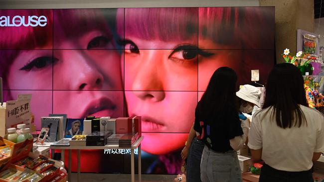 A screen shows a video of celebrity idols at a fan merchandise store at a shopping mall in Beijing. Picture: Jade Gao/AFP