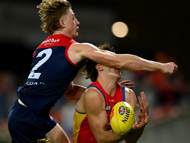 GOLD COAST, AUSTRALIA - MAY 06: Charlie Ballard of the Suns suffers an injury while challenging for the ball against Jacob van Rooyen of the Demons  during the round eight AFL match between the Gold Coast Suns and the Melbourne Demons at Heritage Bank Stadium, on May 06, 2023, in Gold Coast, Australia. (Photo by Albert Perez/AFL Photos via Getty Images)