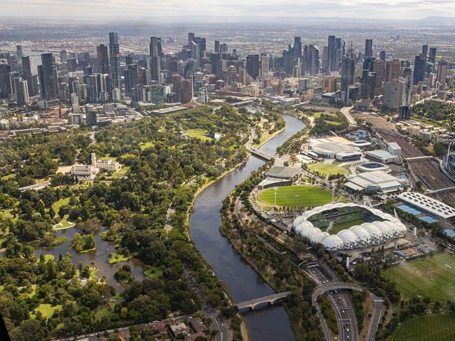 Generic aerial views over Melbourne from Microflight helicopter. Approaching the CBD from the East over the Yarra River, With the MCG, Government House, Royal Botanical Gardens, Tennis Center, Rod Laver Arena, AAMI Park visible. Picture: Jason Edwards