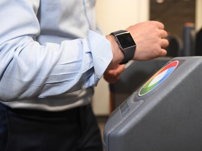 A man uses his smart watch to pay for his train trip at Wynyard Station. Picture: AAP Image/Dean Lewins