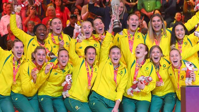 Australian players hold their trophy as they celebrate winning the final of the Netball World Cup against England, in Cape Town on 06 August 2023. (Photo by RODGER BOSCH / AFP)