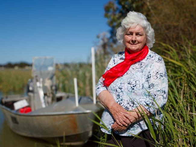 Gloria Jones, wife of the late River Murray campaigner Henry Jones, with his fishing boat in the background in Clayton Bay. Picture Matt Turner.