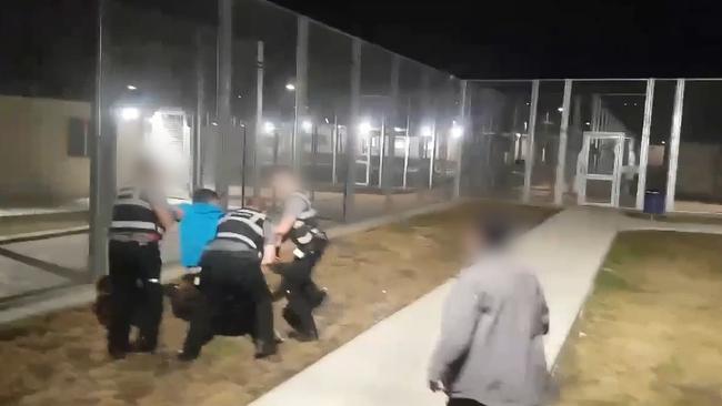 Guards tussle with a man believed to be Mr Yousuf in another incident at the centre five months ago.