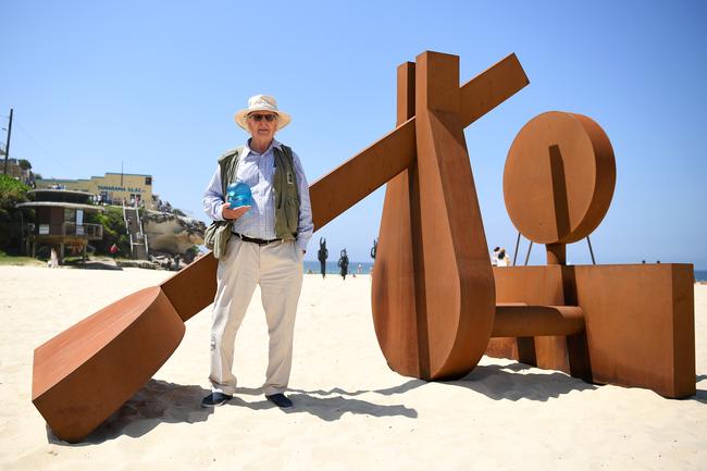 Aqualand Sculpture Award winner Morgan Jones with his corten steel sculpture, The Sun Also Rises, on Tamarama Beach. Picture: Joel Carrett/AAP